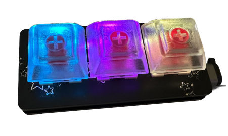 A 3-key custom keyboard with colored glowing translucent keys.